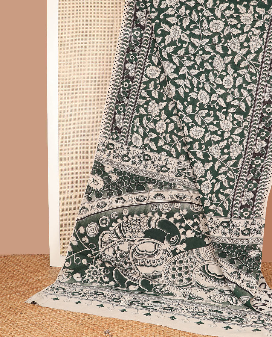 Deep green floral vine machine-printed kalamkari cotton saree, floral and chevron printed border, and pallu of kalamkari peacock