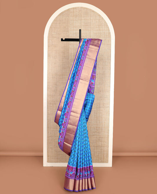 Blue buttas enclosed jaal patola silk saree, contrast temple zari border of swan motifs, and pallu of swan and diamond motifs