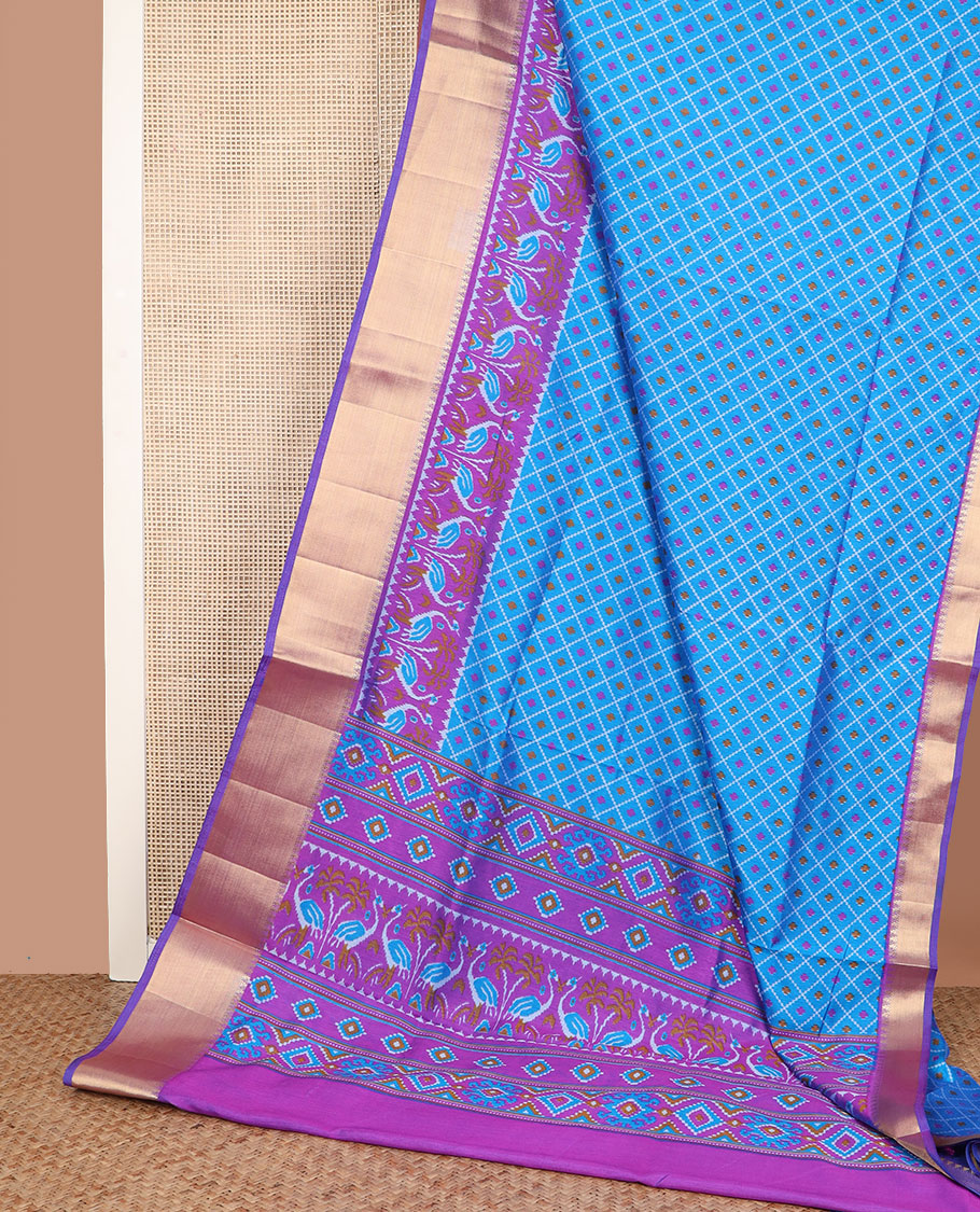 Blue buttas enclosed jaal patola silk saree, contrast temple zari border of swan motifs, and pallu of swan and diamond motifs