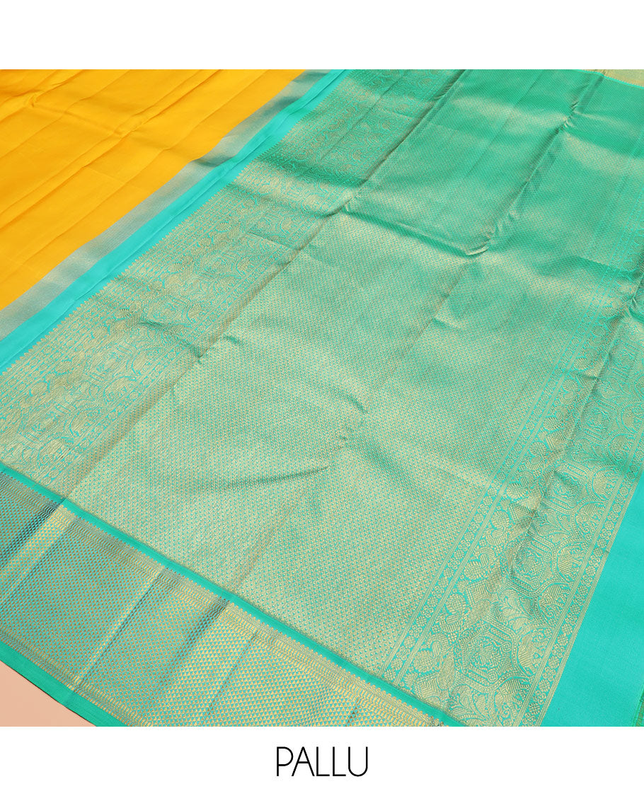 Yellow plain Kanchipuram silk saree, contrast border of salngai, muthu, and ara maadam designs, and intricate pallu