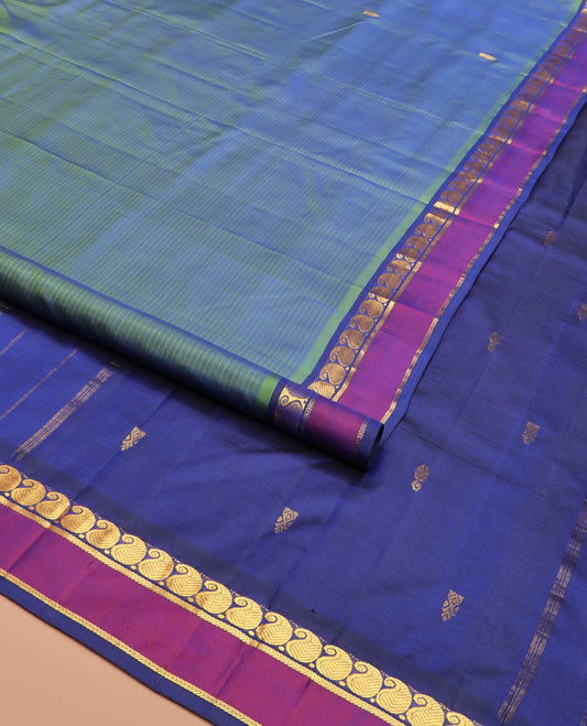 Green Striped Kanchipuram Silk Saree with Zari Buttas, Complemented with Contrast Rettai Pettu Border Features Manga and Kathir Designs, Pallu Subtly Woven with Zari Buttas, and Paired with a Contrast Blouse