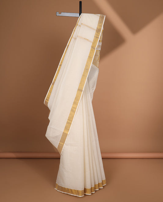 Cream kerala saree with zari designs, zari border & pallu of intricate designs
