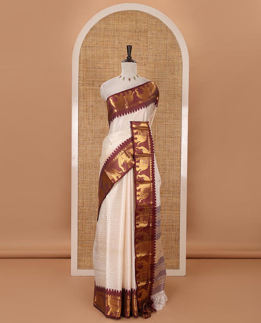 White checked semi-tafeta saree, contrast maroon temple zari elephant motifs border, zari-rich pallu & contrast checked zari border blouse