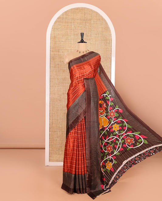 Rust Orange Turkey Crepe Saree Featuring Horizontal Stripes All Over Its Body, Complemented by Contrast Traditional Patterned Border, Vibrant Pallu of Colorful Kalamkari Floral and Peacock Prints, and Paired with a Contrast Blouse