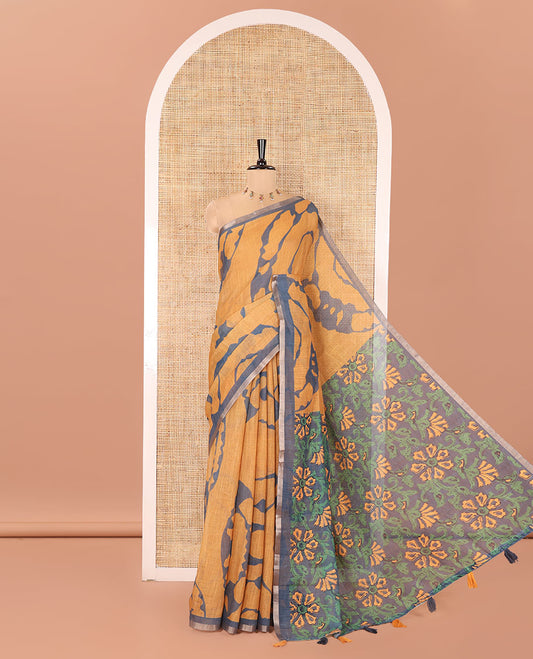 Mustard Linen Cotton Saree, Adorned with Shibori Prints on Its Body, Subtle Contrast Piping Border, Pallu of Floral Print, and Paired with a Matching Blouse