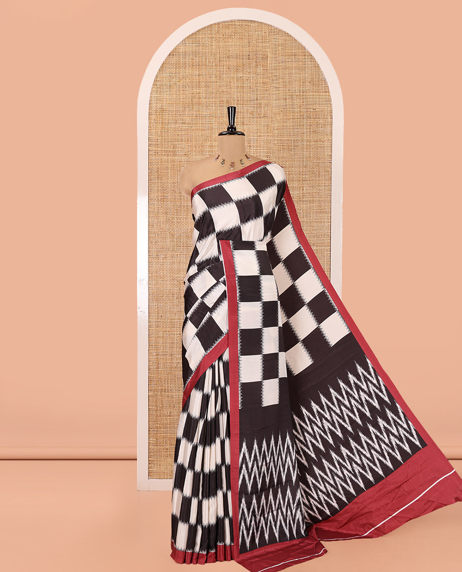 Cream and Black Satin Crepe Saree, Highlighted with Chess-Style Checked Design in Ikkat Weave, Complemented by a Contrast Border, Ikkat Chevron Printed Pallu, and Paired with a Contrast Blouse