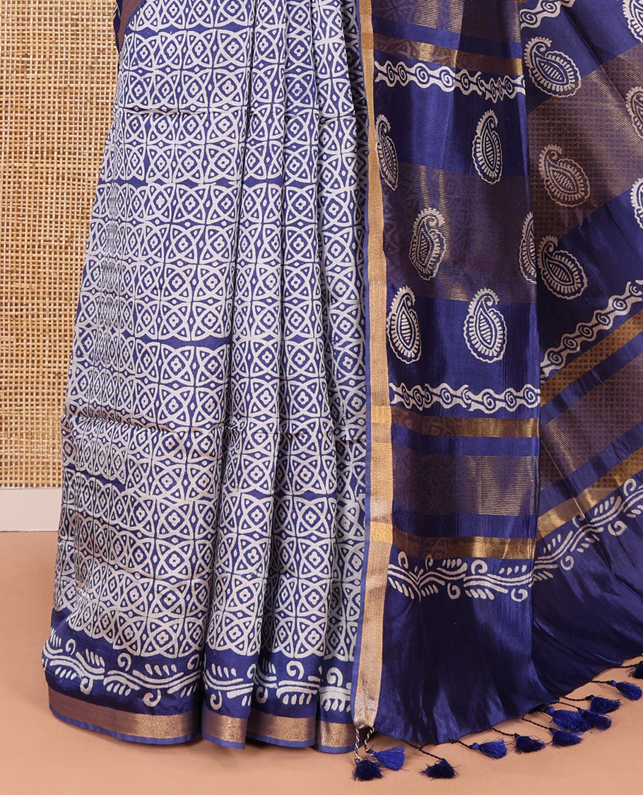 Blue geometric batik printed banana pith saree, printed piping border, paisley motifs steeped pallu, and a matching blouse
