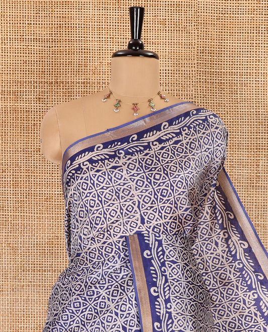 Blue geometric batik printed banana pith saree, printed piping border, paisley motifs steeped pallu, and a matching blouse