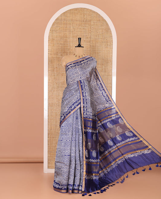 Blue geometric batik printed banana pith saree, printed piping border, paisley motifs steeped pallu, and a matching blouse