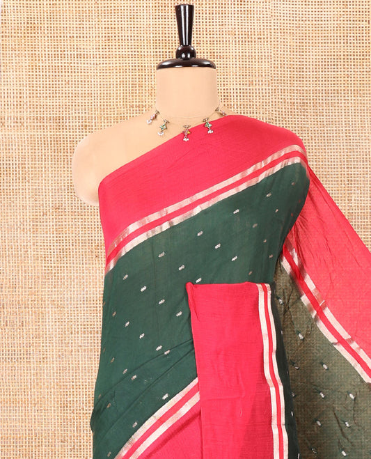 Bottle Green Assam Silk Saree, Accentuated with Zari Buttas on Its Body, Complemented by Contrast Zari Striped Border, Pallu Steeped with Gleaming Zari Stripes and Buttas, and Paired with a Contrast Blouse