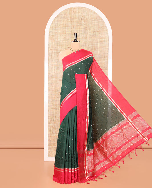 Bottle Green Assam Silk Saree, Accentuated with Zari Buttas on Its Body, Complemented by Contrast Zari Striped Border, Pallu Steeped with Gleaming Zari Stripes and Buttas, and Paired with a Contrast Blouse