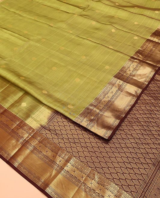 Green Vasundhara Lite Silk Mix Saree, Subtly Woven with Zari Buttas on Its Body, Complemented by a Contrast Border of Kodi Visiry and Chakram Designs, Pallu of Jaal Designs, and Paired with a Contrast Blouse