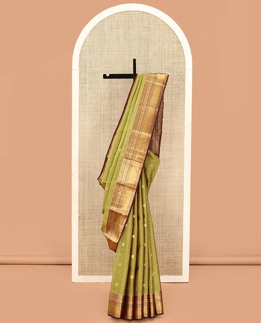 Green Vasundhara Lite Silk Mix Saree, Subtly Woven with Zari Buttas on Its Body, Complemented by a Contrast Border of Kodi Visiry and Chakram Designs, Pallu of Jaal Designs, and Paired with a Contrast Blouse