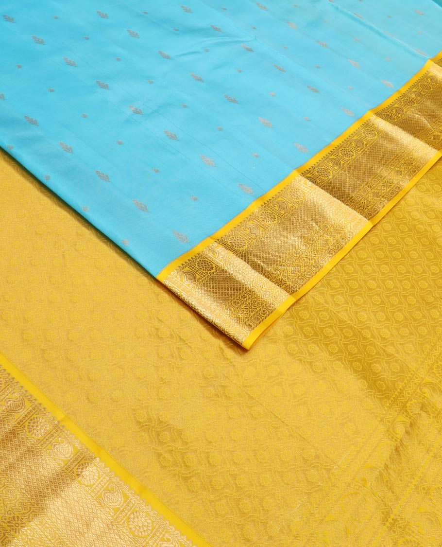 Blue zari buttas Vasundhara silk saree, contrast border of rekku, manga, chakram, mayil kann, and rudraksham designs, and intricate pallu