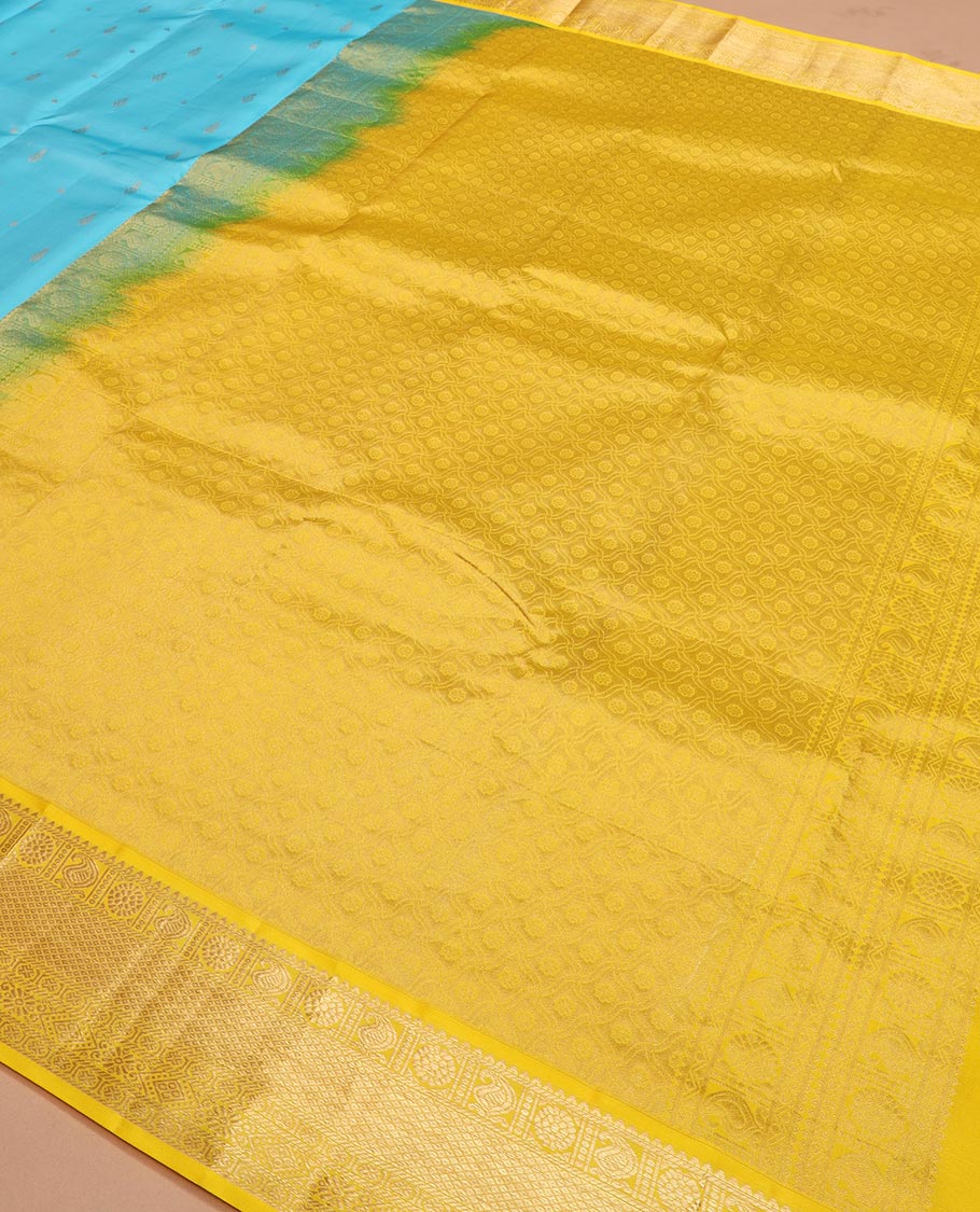 Blue zari buttas Vasundhara silk saree, contrast border of rekku, manga, chakram, mayil kann, and rudraksham designs, and intricate pallu