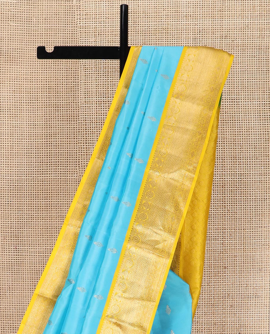 Blue zari buttas Vasundhara silk saree, contrast border of rekku, manga, chakram, mayil kann, and rudraksham designs, and intricate pallu