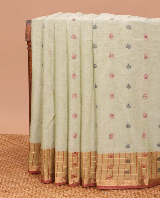 Pastel green chakra, and paisley buttas Coimbatore cotton saree, contrast butta enclosed checked border, and pallu of paisleys and chevron design