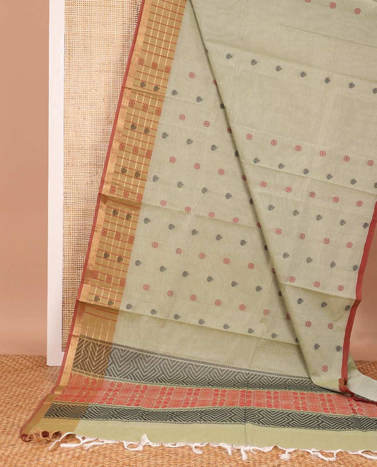 Pastel green chakra, and paisley buttas Coimbatore cotton saree, contrast butta enclosed checked border, and pallu of paisleys and chevron design