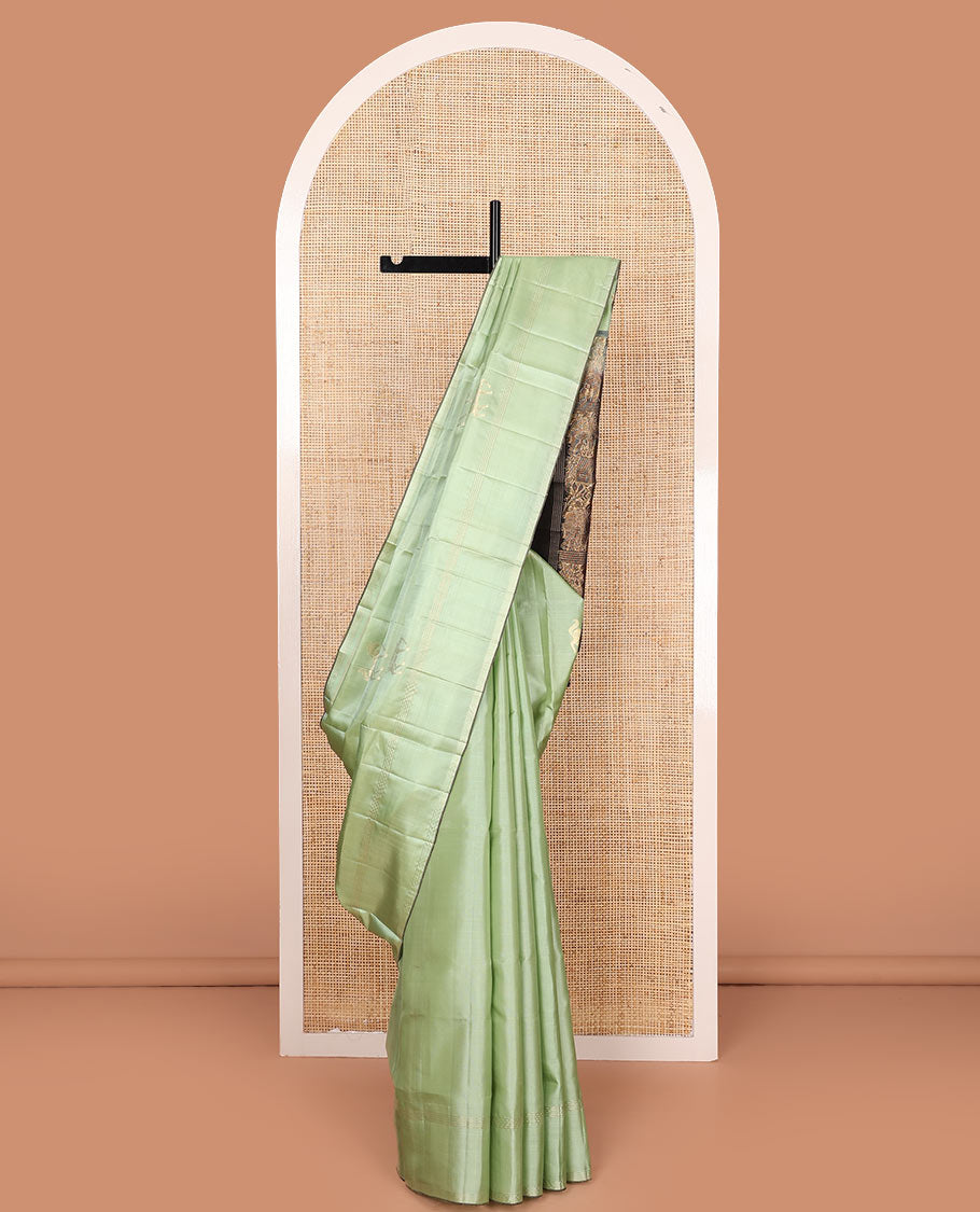 Green yaanai buttas soft silk saree, zari striped border, and contrast yaanai and house motifs woven pallu