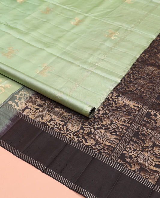 Green yaanai buttas soft silk saree, zari striped border, and contrast yaanai and house motifs woven pallu