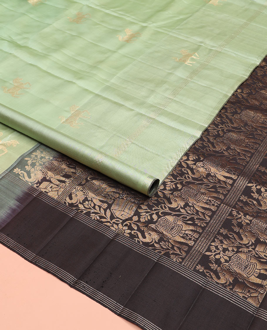 Green yaanai buttas soft silk saree, zari striped border, and contrast yaanai and house motifs woven pallu