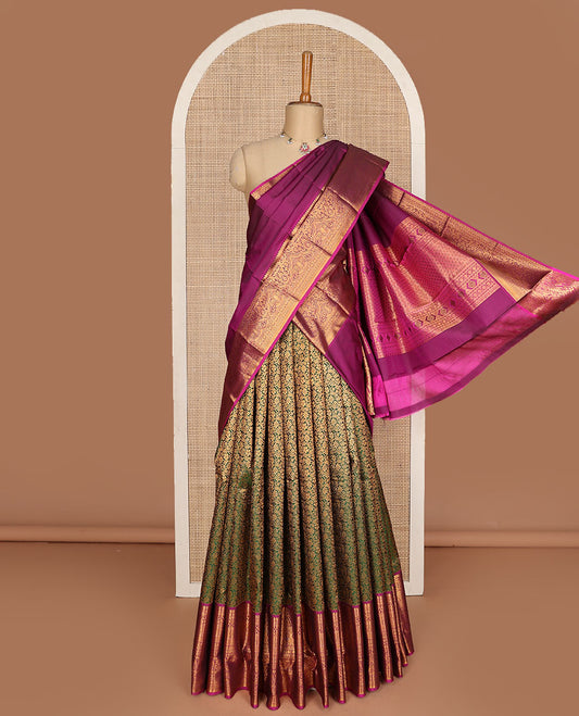 Green pure-silk half-saree, floral jacquard skirt, contrast blouse, and border of salangai, muthu, kamalam, kodi visiry and traditional designs, and intricate dhavani