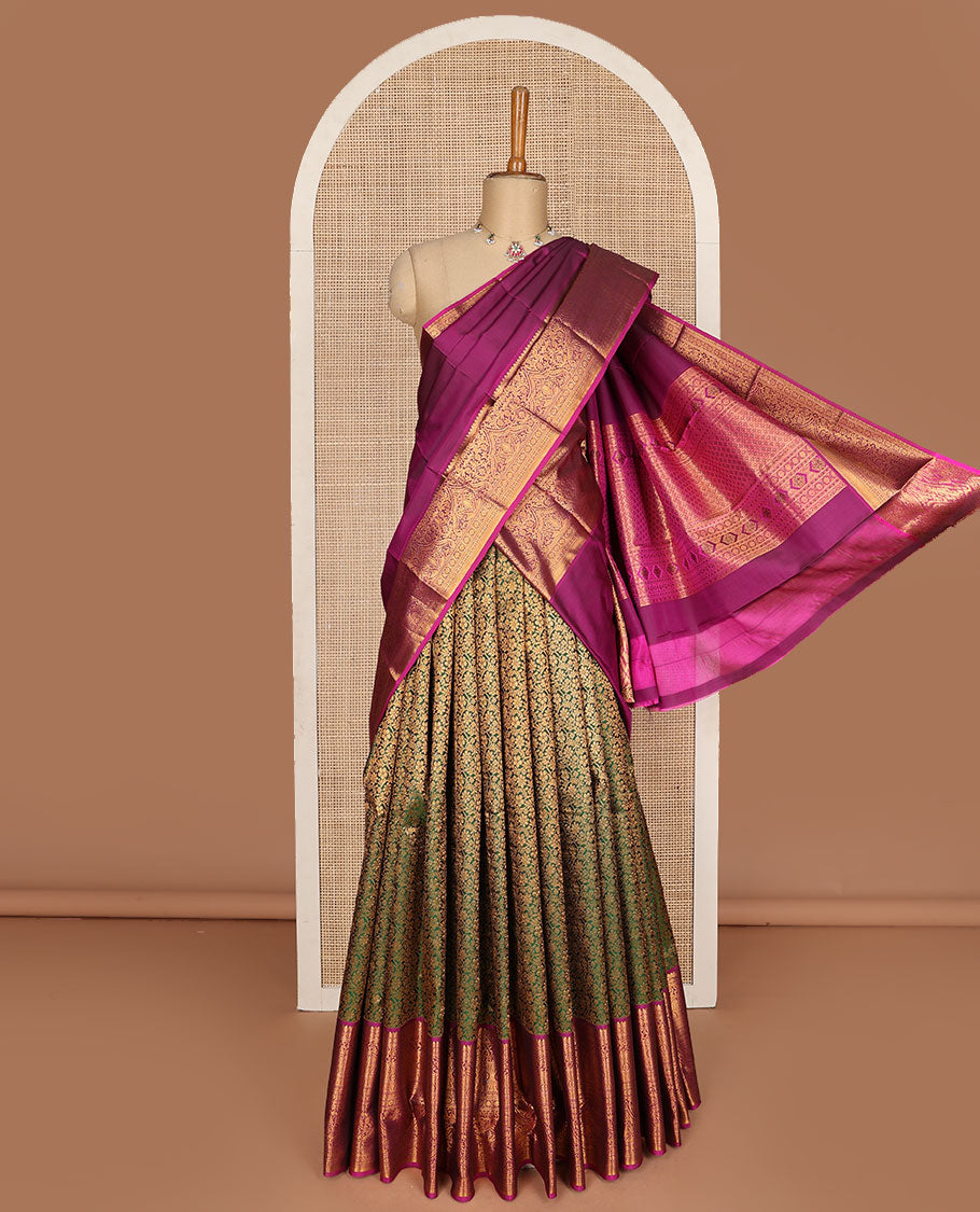 Green pure-silk half-saree, floral jacquard skirt, contrast blouse, and border of salangai, muthu, kamalam, kodi visiry and traditional designs, and intricate dhavani