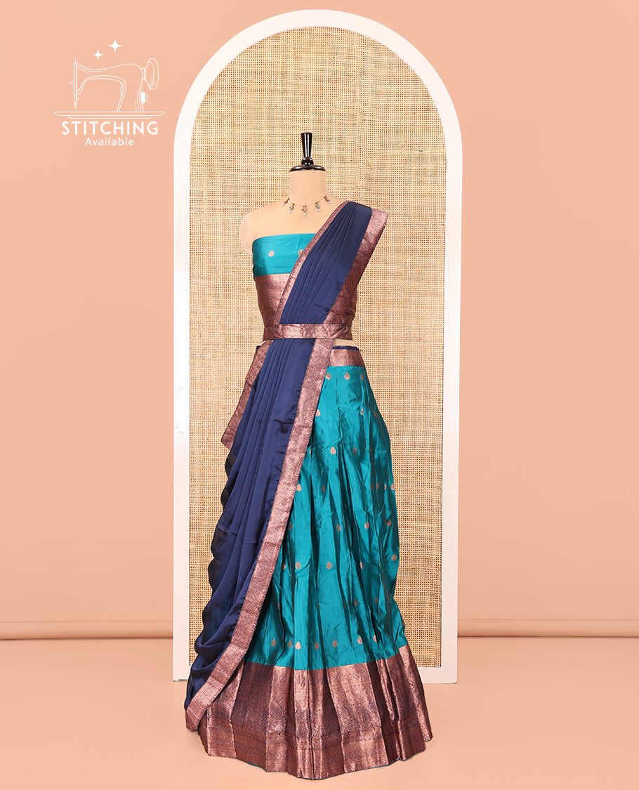 Rama-Navy Blue Semi-Banarasi Half-Saree Features Buttas on Skirt, a Contrast Traditional Zari Border, a Matching Blouse, and a Contrast Satin Georgette Dhavani