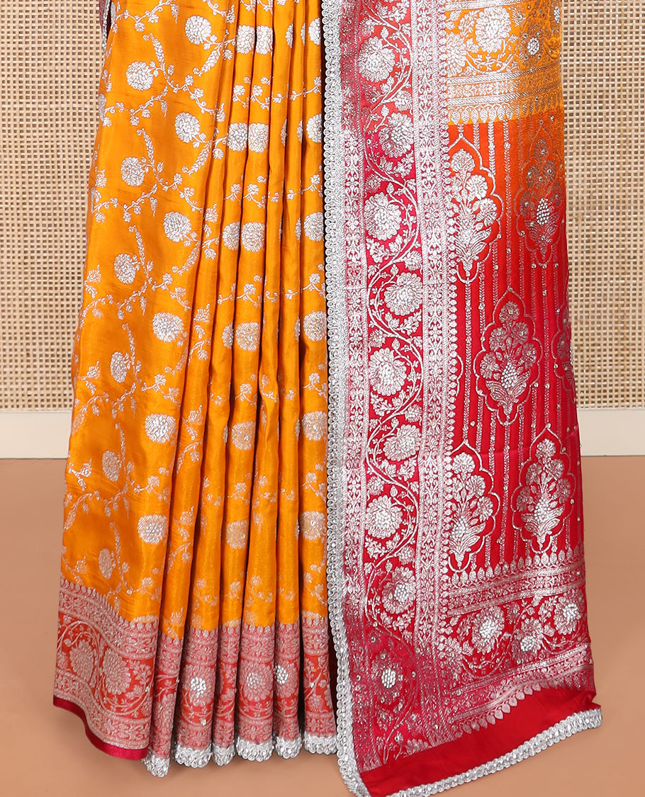 Orange Semi-Banaras Nylon Saree Highlighted with Floral Jaal Jacquard and Stone Work, Complemented by a Contrast Floral Creeper Zari Stone Work Lace Border, Floral Bouquets Themed Pallu Detailed in Zari and Stone Work, and Paired with a Contrast Blouse
