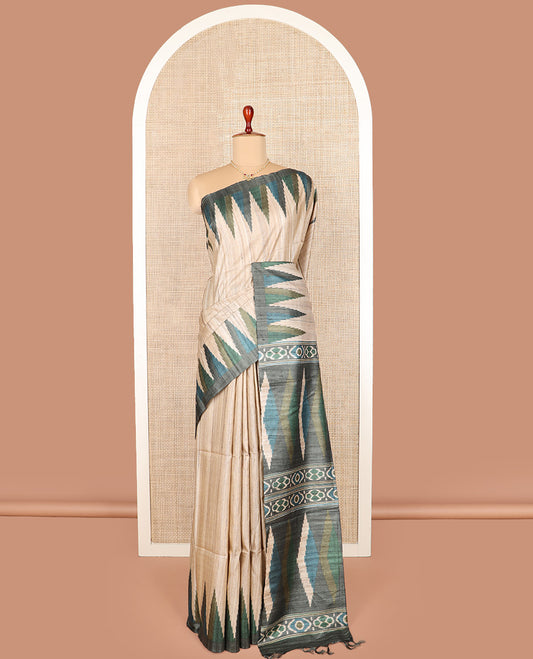 Light sandal plain tussar saree, contrast temple border, and geometric patterned pallu