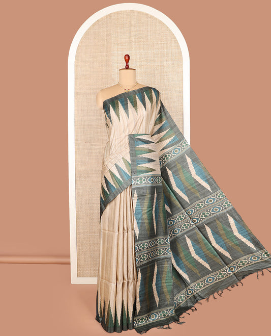 Light sandal plain tussar saree, contrast temple border, and geometric patterned pallu
