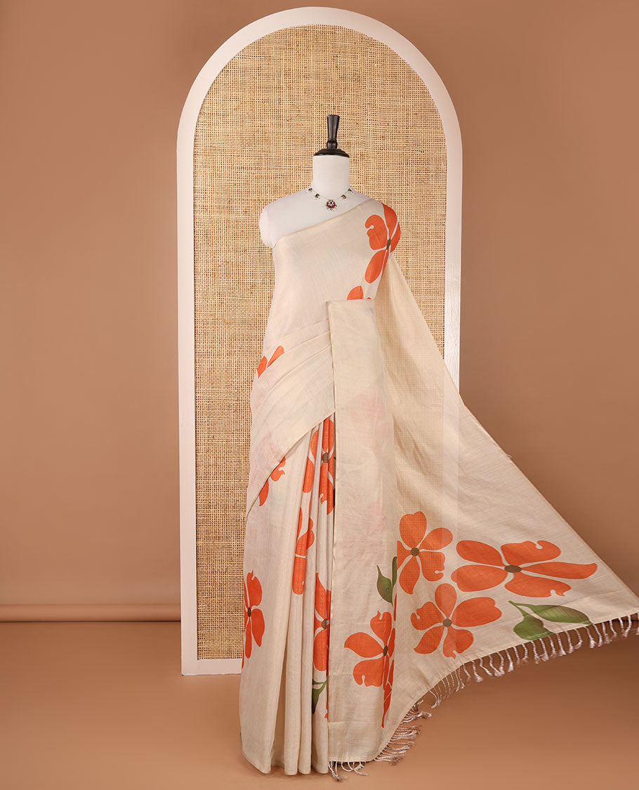 Borderless cream printed onam tissue silk saree features orange color five-petal flower & leaf motifs print, matching floral print blouse