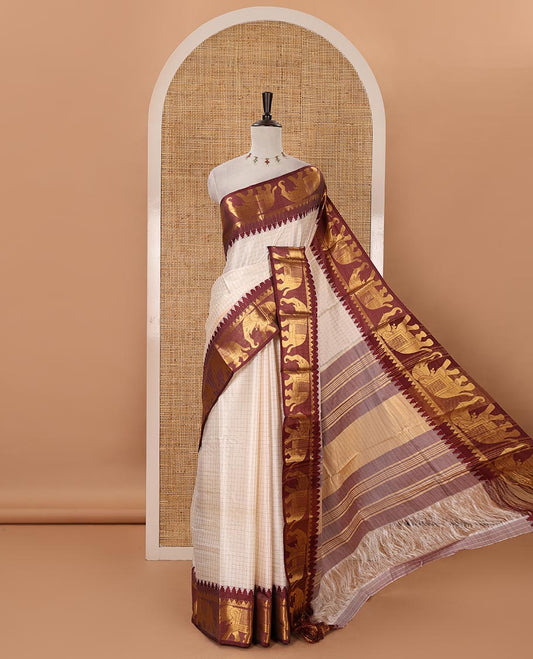 White checked semi-tafeta saree, contrast maroon temple zari elephant motifs border, zari-rich pallu & contrast checked zari border blouse