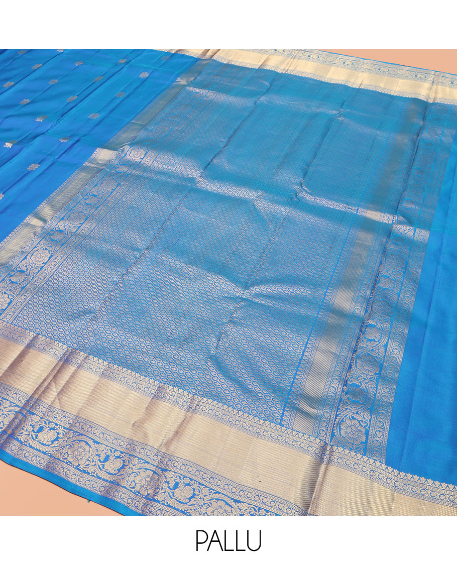 Blue Vasundhara Silk Saree, Mesmerized with Zari Buttas All Over Its Body, Highlighted by a Zari Border of Kodi Visiry, and Mayil Designs, Grand Jaal Pallu, and Paired with a Matching Blouse