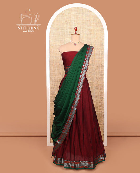 Maroon plain cotton half-saree with contrast traditional bordered skirt, matching blouse, and a contrast traditional bordered dhavani