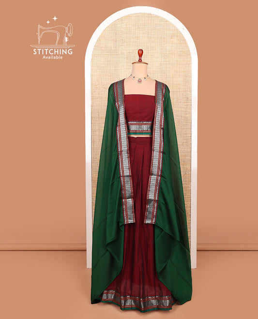 Maroon plain cotton half-saree with contrast traditional bordered skirt, matching blouse, and a contrast traditional bordered dhavani