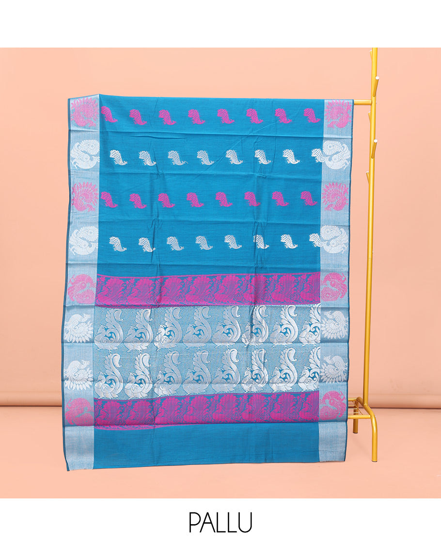 Blue Semi-Silk Cotton Saree, Uniquely Detailed with Peacock Buttas All Over Its Body, Highlighted by a Zari Border of Peacock Designs, Pallu Steeped with Peacock Zari Motifs, and Paired with a Matching Blouse