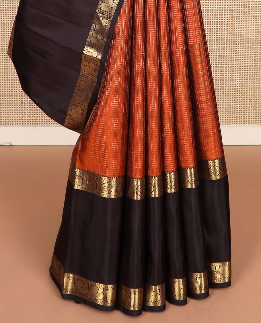 Orange micro-zari checked Kanchipuram silk saree, contrast rettai pettu border of thilakam mokku, rudraksham, and poo chakram and mayil designs, and buttas enclosed jaal pallu