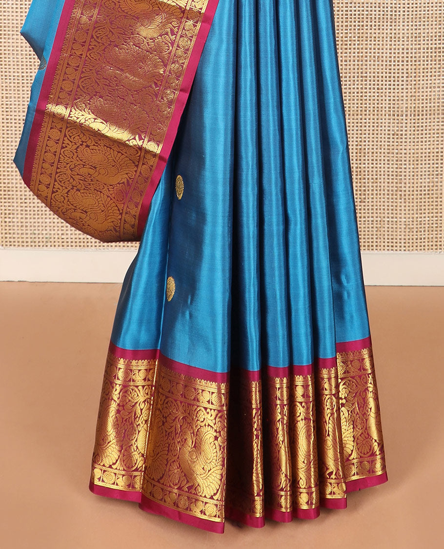 Blue chakram buttas Kanchipuram silk saree, contrast border of mayil chakram designs, and pallu steeped with chakram motifs