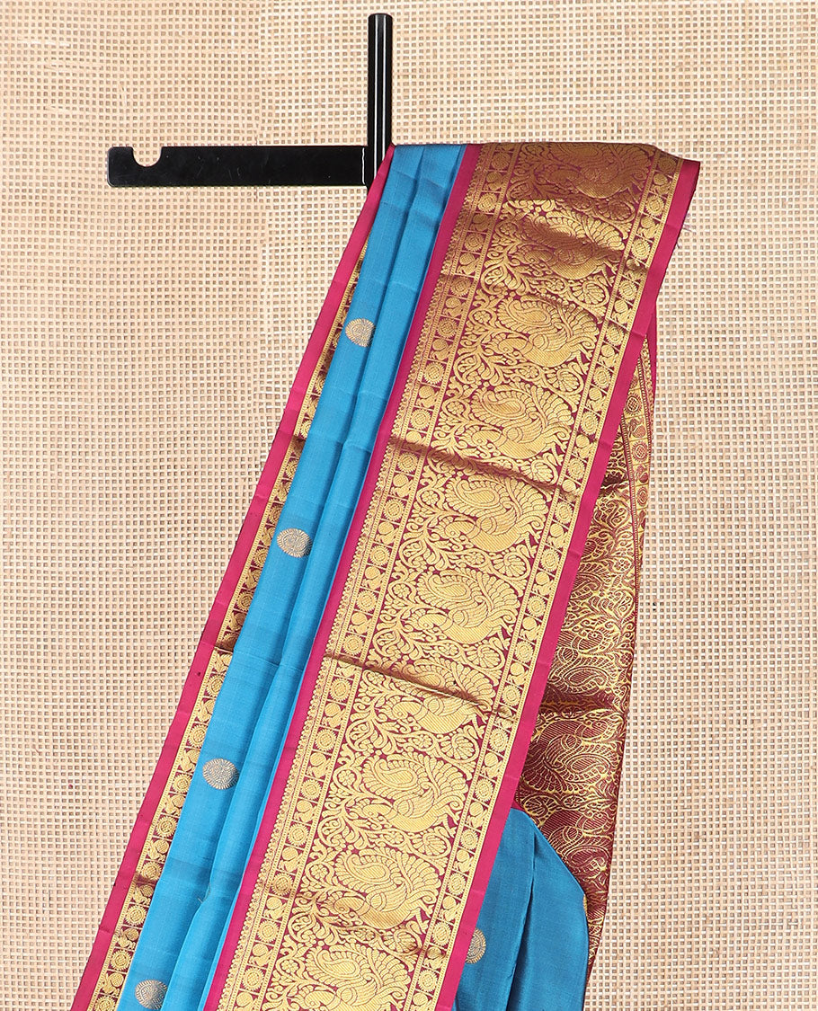 Blue chakram buttas Kanchipuram silk saree, contrast border of mayil chakram designs, and pallu steeped with chakram motifs
