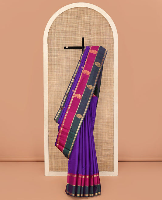 Purple Kanchipuram Silk Saree, Mesmerized with Buttas and Vazhaipoo Stripes All Over Its Body, Complemented by a Contrast Border of Muthu, Kathir, and Arumbu Manga Designs, Sparsely Woven Pallu, and Paired with a Contrast Blouse