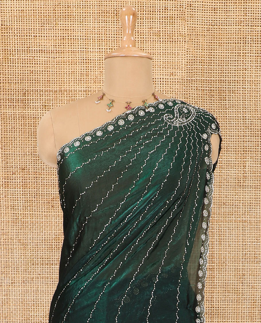 Green micro-stone work fendy chiffon saree with paisley stone work on its shoulder, a scallop stone work border, a butterfly style pallu, and a matching stone work blouse