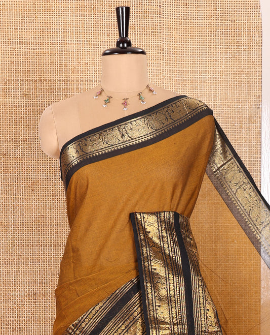 Mustard Plain Chettinad Cotton Saree, Complemented by a Contrast Temple Rettai Pettu Border Featuring Elephant, and Peacock Motifs, Subtly Striped Pallu, and Paired with a Matching Blouse