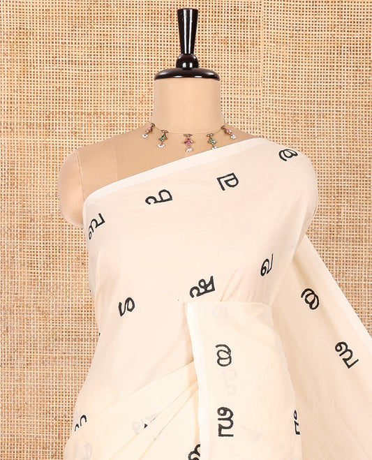 Borderless Cream South Cotton Saree, Accentuated with Malayalam Letter Motifs Printed All Over Its Body, Pallu Mirrors the Same Print, and Paired with a One Matching Blouse, and One Contrast Printed Blouse