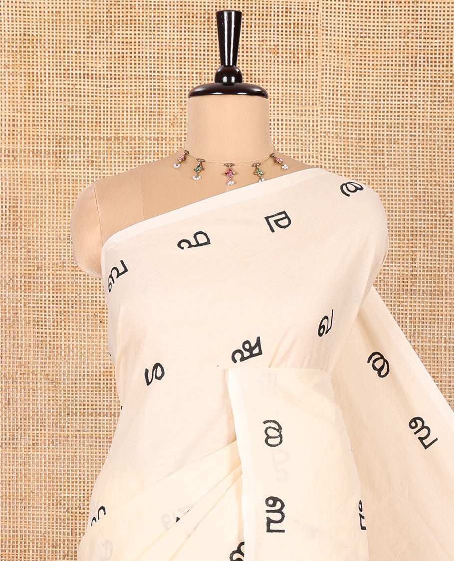 Borderless Cream South Cotton Saree, Accentuated with Malayalam Letter Motifs Printed All Over Its Body, Pallu Mirrors the Same Print, and Paired with a One Matching Blouse, and One Contrast Printed Blouse