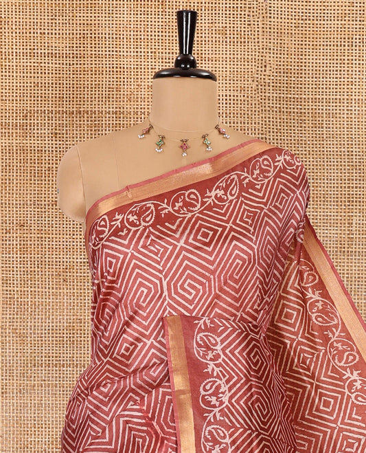 Rust diamond patterns batik printed banana pith saree, printed piping border, printed pallu, and a matching blouse