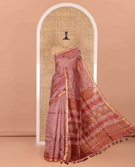 Rust diamond patterns batik printed banana pith saree, printed piping border, printed pallu, and a matching blouse