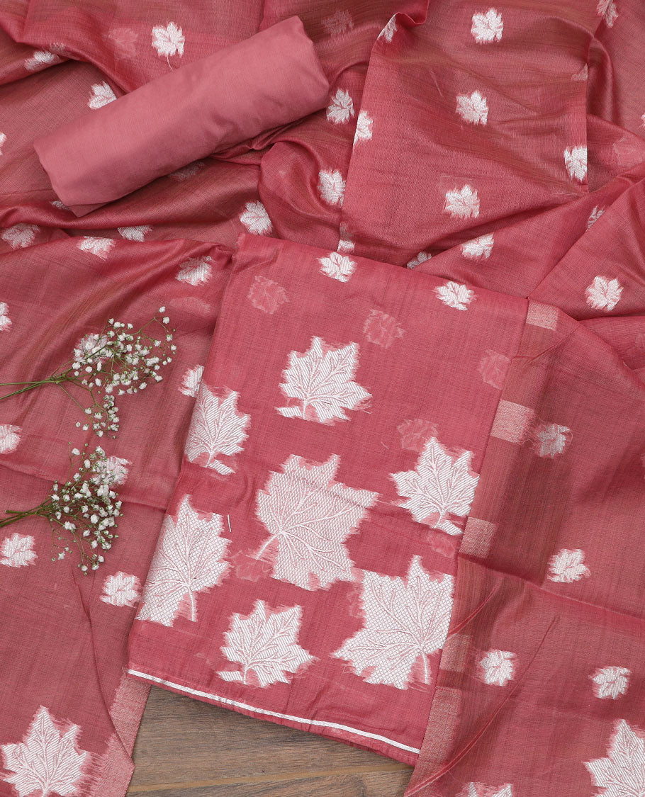 Pink material churidar set, leaf motifs top, plain bottom, and a dupatta steeped with leaf motifs