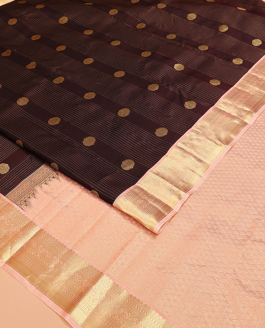 Brown Vasundhara Lite Silk Mix Saree, Prettified with Stripes, and Chakram Buttas, Complemented by a Contrast Border of Thilakam Mokku, Muthu, Banaras, Neli, and Mayil Designs, Pallu Steeped with Peacock Feather Designs, and Paired with a Contrast Blouse