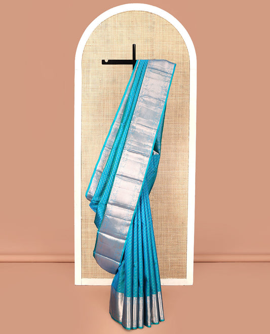 Blue Vasundhara Silk Saree, Beautifully Bedecked with Zig-Zag Stripes All Over Its Body, Highlighted by a Zari Border of Rekku, Muthu, Neli, Mayil, and Yaali Designs, Grand Jaal Pallu, and Paired with a Matching Blouse